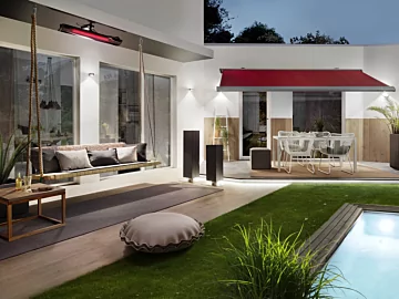 Heatscope Pure 3000W Radiant Heater mounts above the cushioned patio setting in a private residence, supplying efficient outdoor infrared heat.